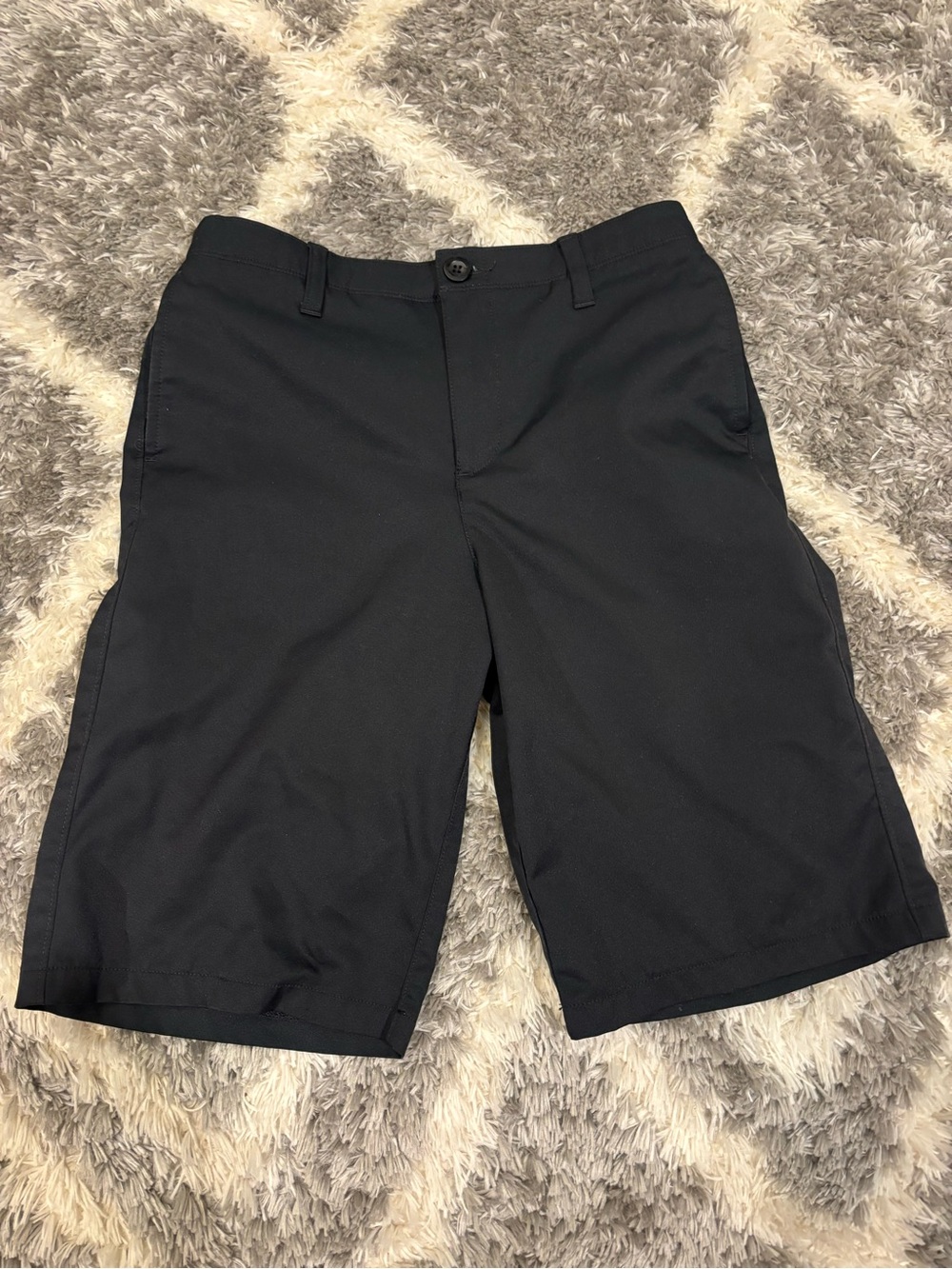 Under armor youth 16 button front black golf shorts.